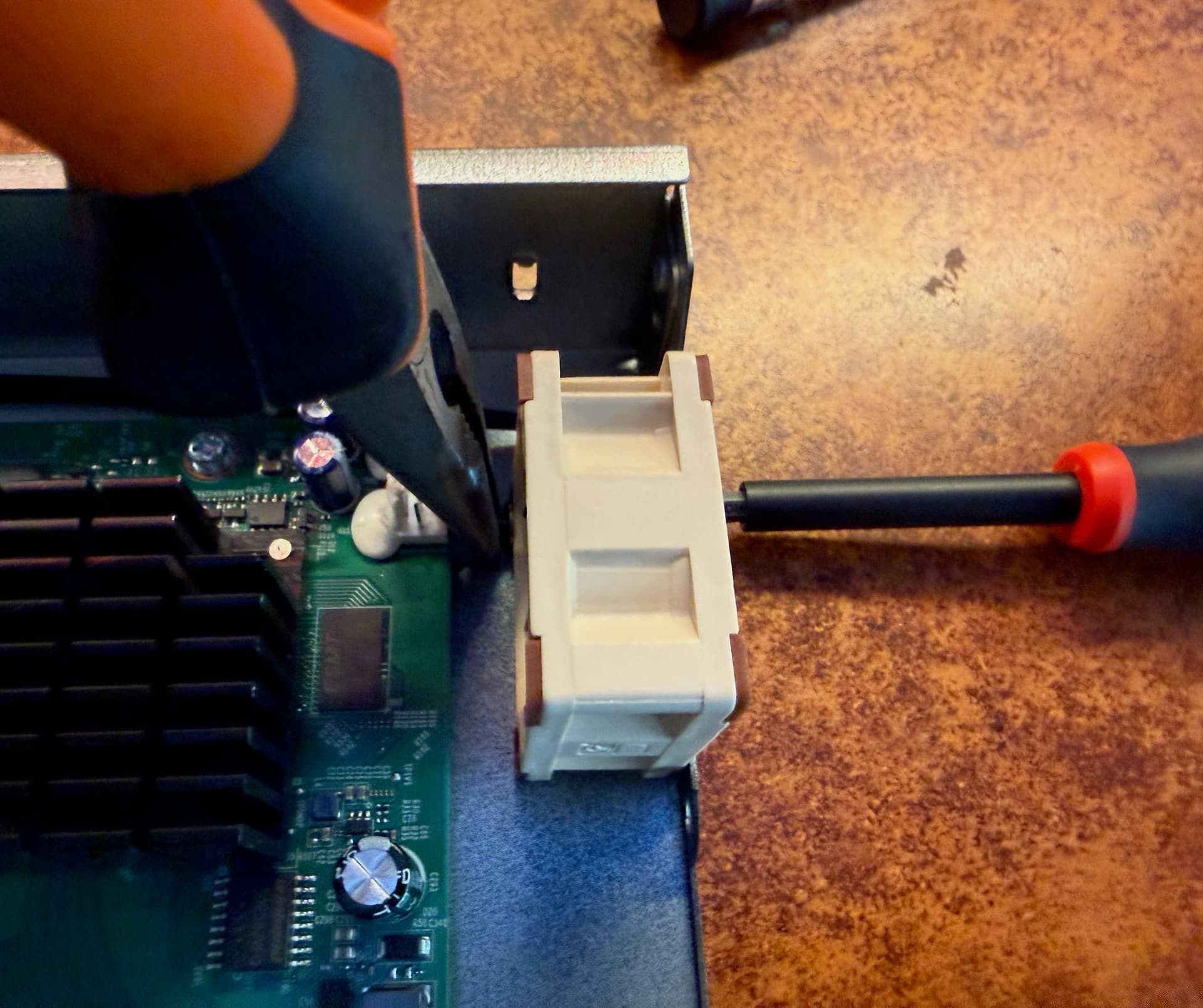 Using pliers to hold the nut while screwing it back on