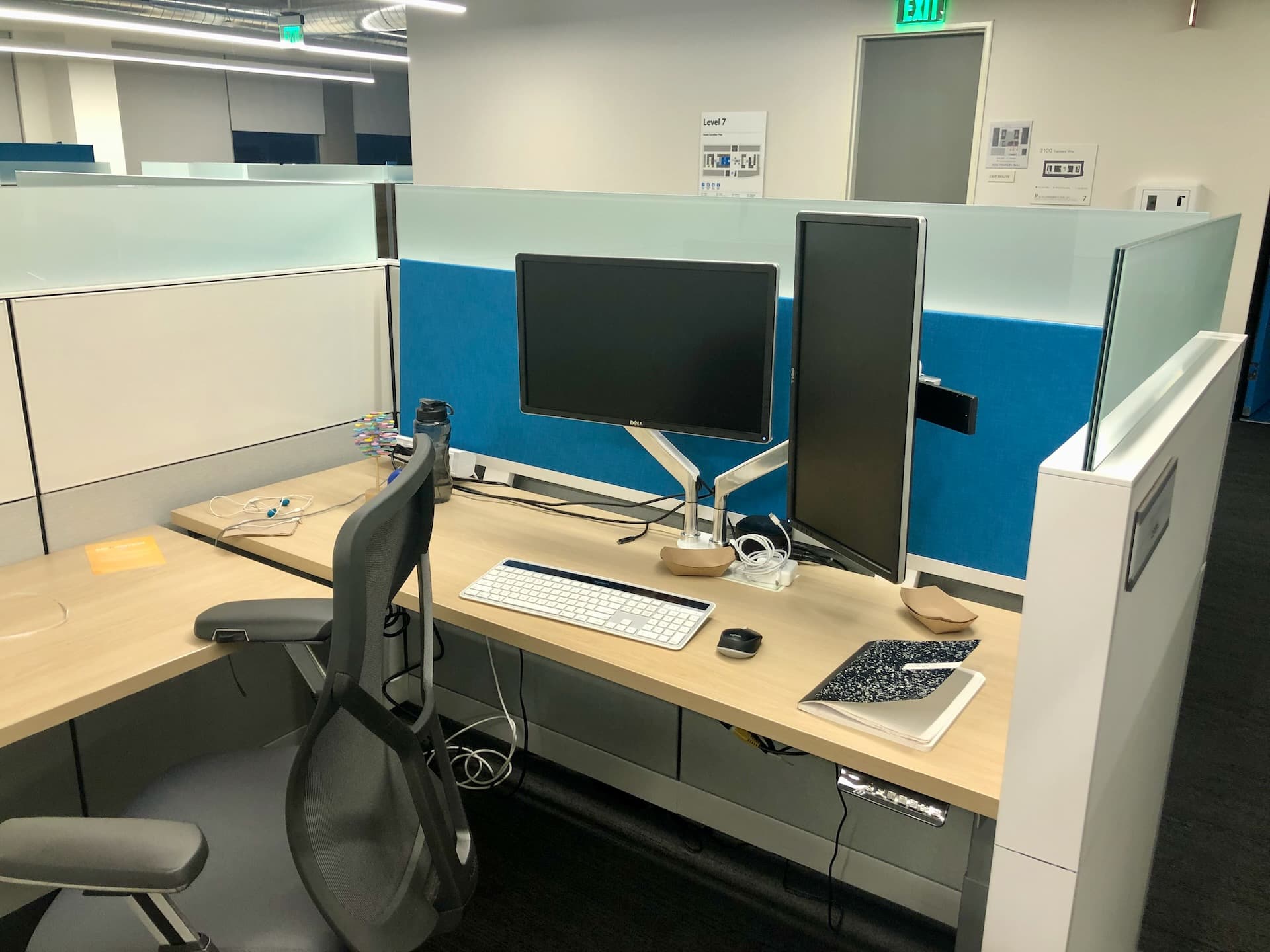 Image of a typical desk setup at a tech firm, with a laptop and a single external monitor